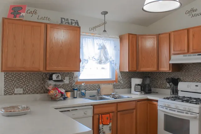 a kitchen with a sink stove and cabinets