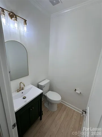 a bathroom with a sink mirror and toilet