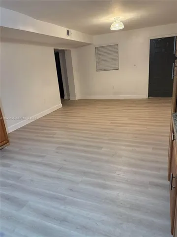 a view of hallway with wooden floor