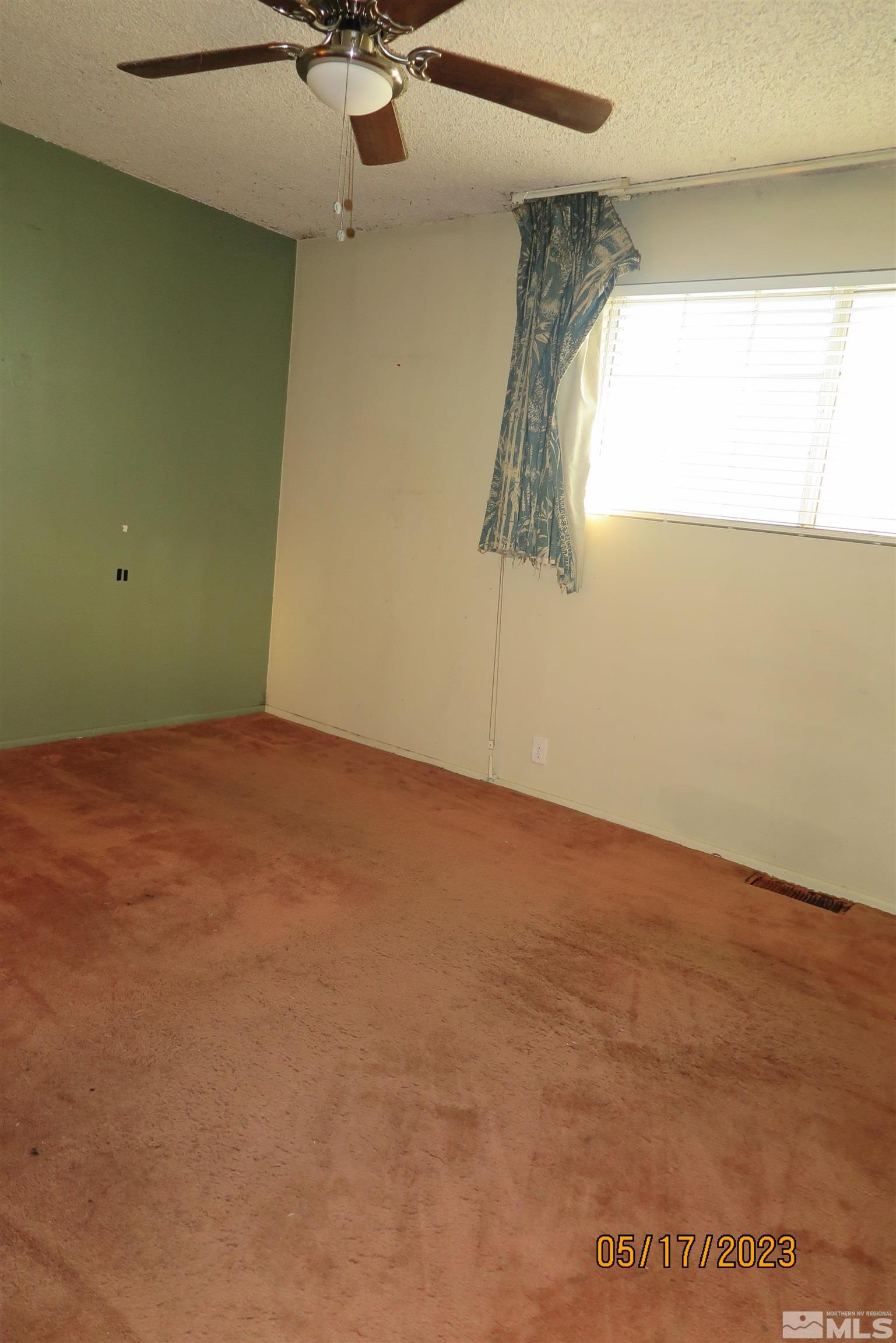 208 Rhodes Road Reno, NV 89521 - Photo 27 of 33 an empty room with a window and a ceiling fan