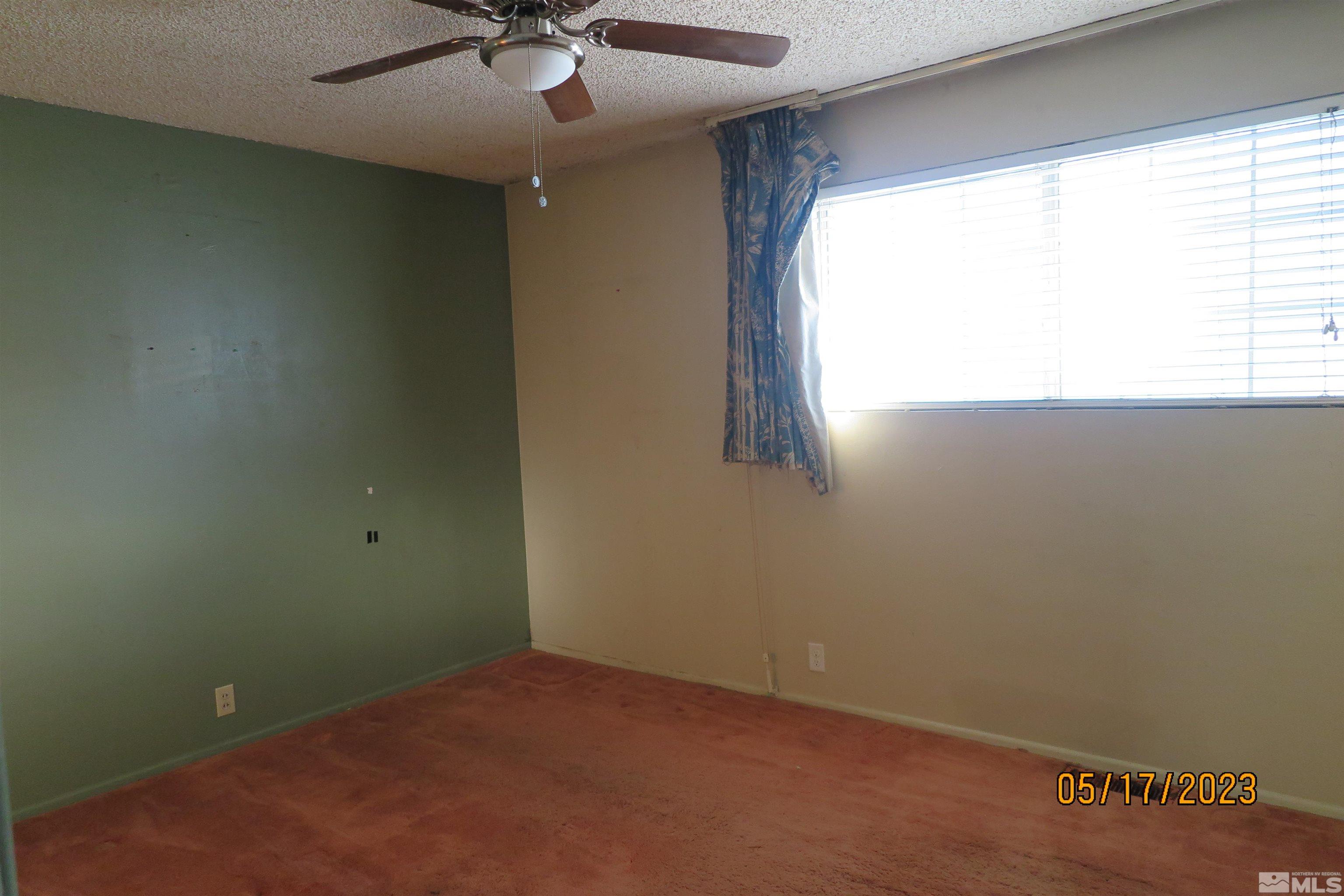 208 Rhodes Road Reno, NV 89521 - Photo 29 of 33 an empty room with a window and a fan