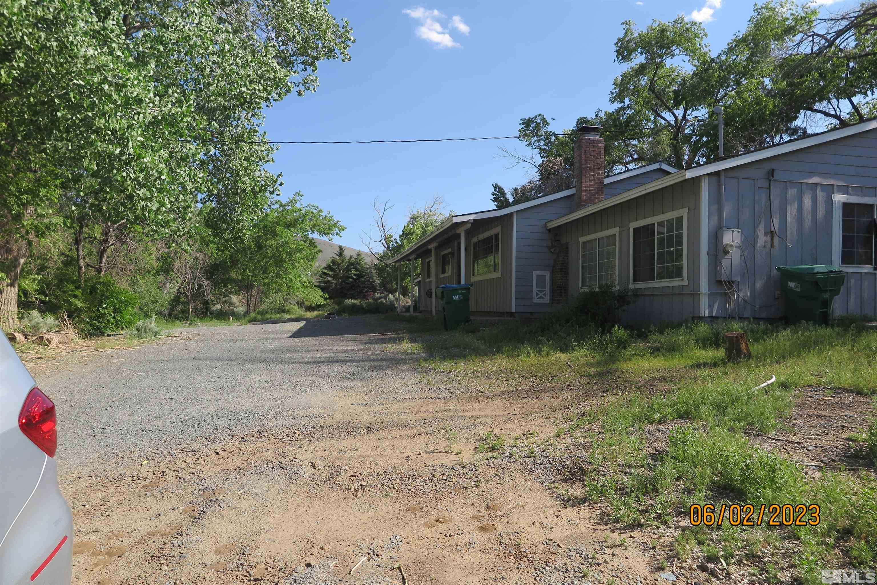 208 Rhodes Road Reno, NV 89521 - Photo 3 of 33 a view of a house with a yard