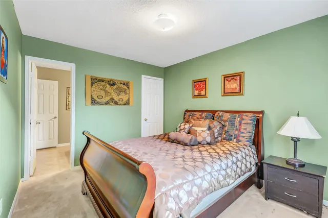 a bedroom with a bed and a lamp on table