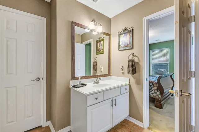 a bathroom with a sink vanity and a mirror