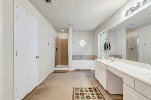 a large room with a large window and double vanity