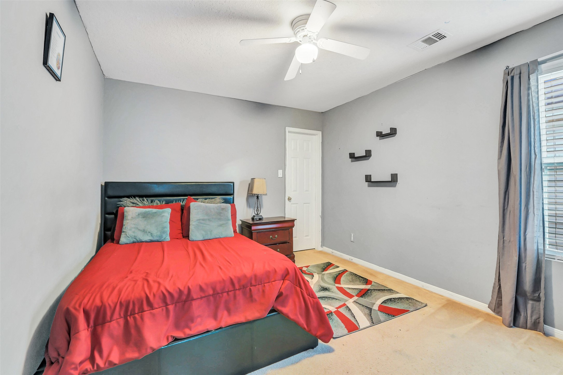 3407 Apple Dale Drive Houston, TX 77084 - Photo 27 of 37 a bedroom with a bed and a chandelier