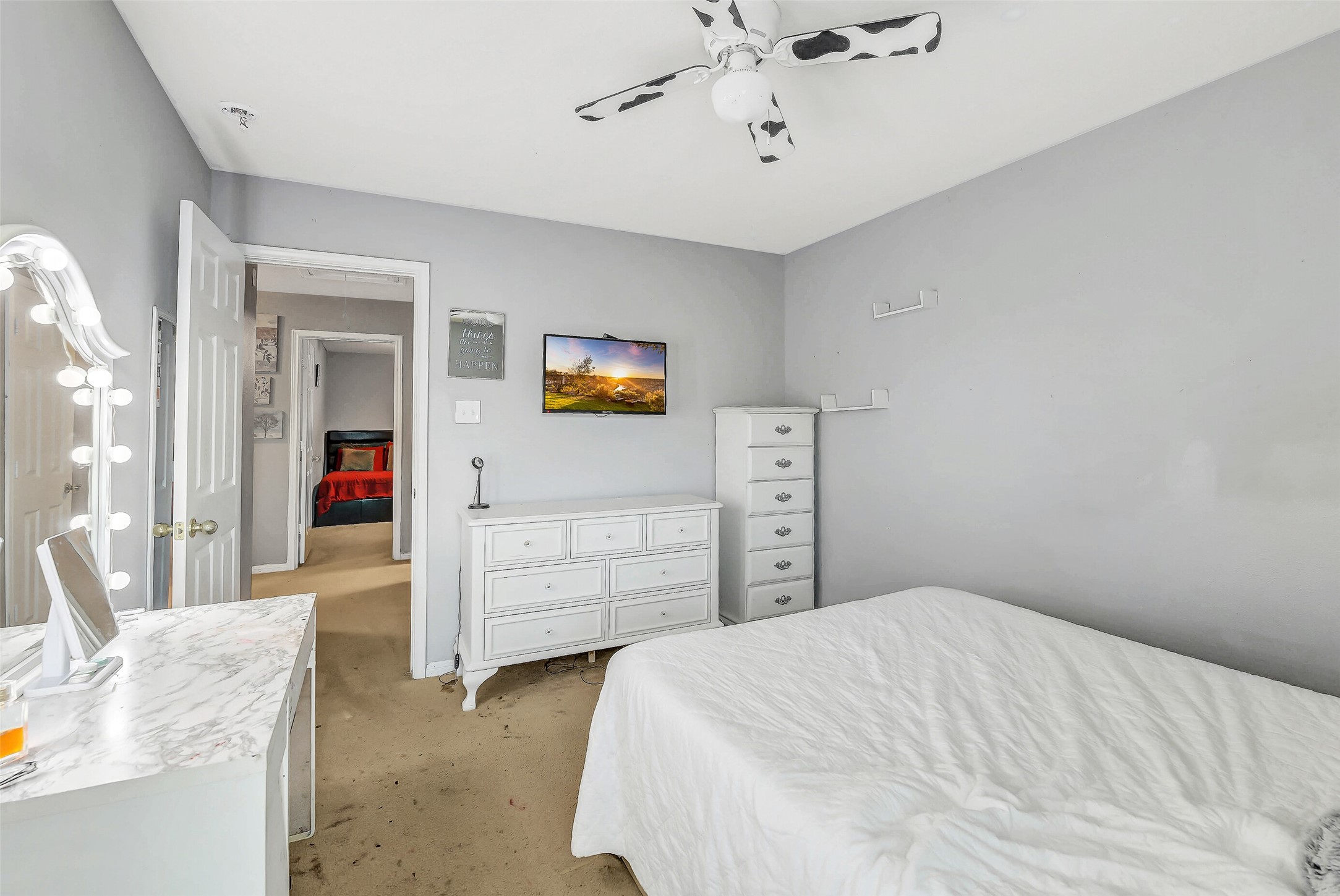 3407 Apple Dale Drive Houston, TX 77084 - Photo 32 of 37 a bedroom with a bed and a chandelier