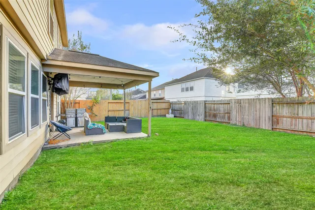 a view of a house with a yard and sitting area