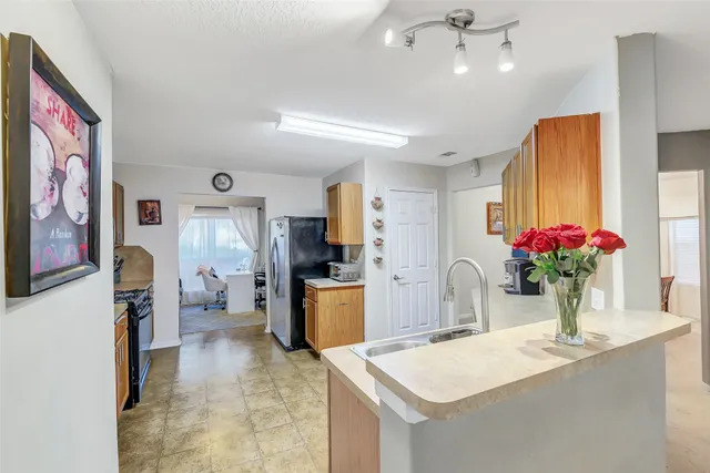 a kitchen that has a refrigerator and a stove