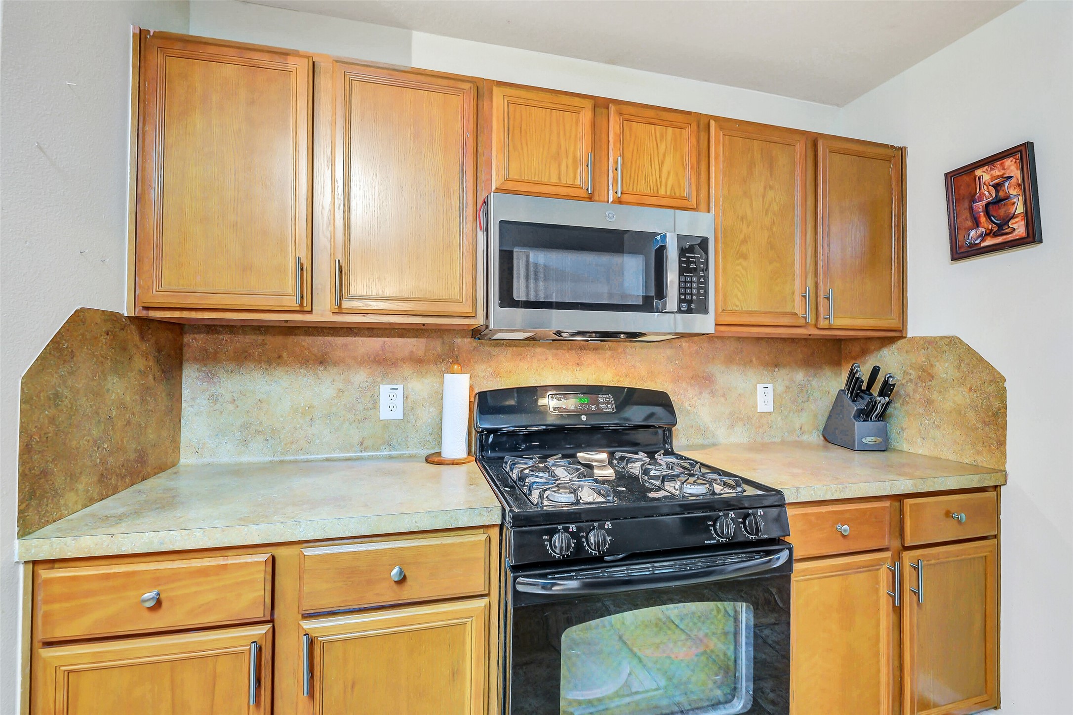3407 Apple Dale Drive Houston, TX 77084 - Photo 10 of 37 a kitchen with granite countertop cabinets stainless steel appliances and wooden cabinets