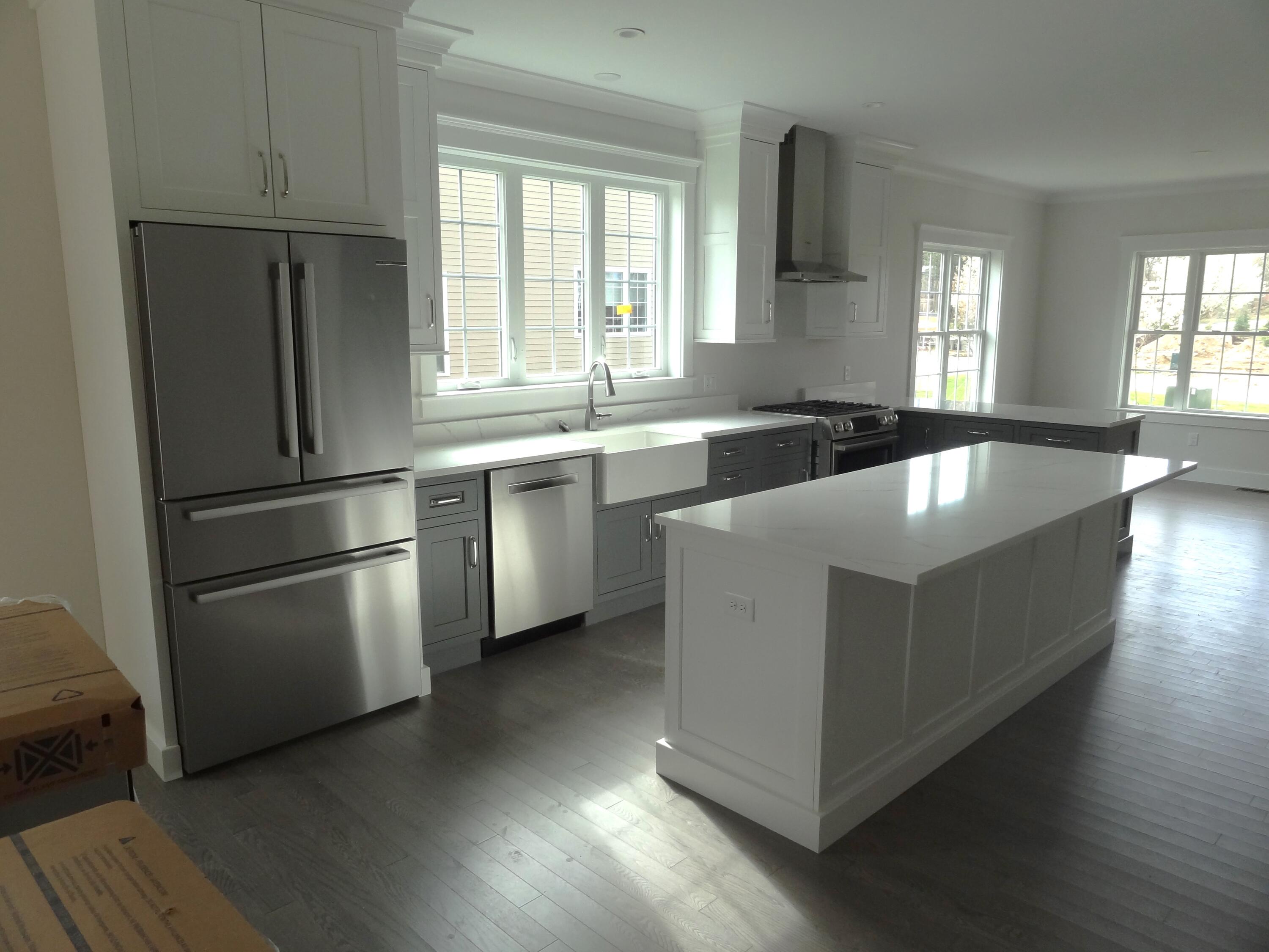 9 Cpe Clb Road East Falmouth, MA 02536 - Photo 8 of 58 a large kitchen with stainless steel appliances granite countertop a refrigerator a sink a stove and wooden floors