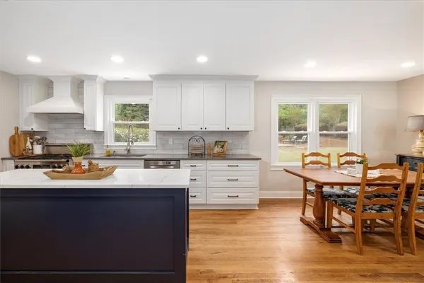 a stove top oven sitting inside of a kitchen