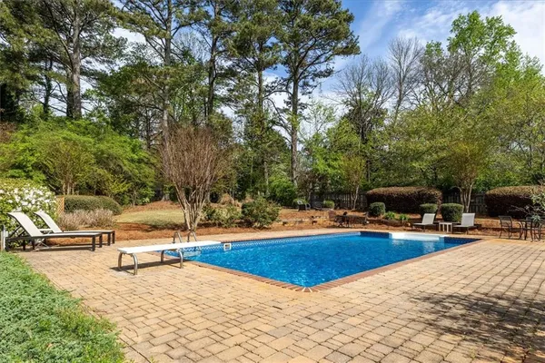 a front view of a house with swimming pool and sitting area