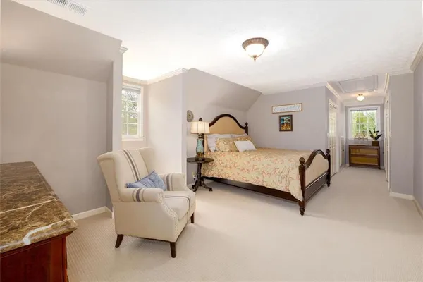 a spacious bedroom with a bed and a chandelier