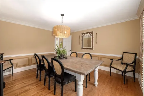 a kitchen with a stove a sink a dining table and chairs