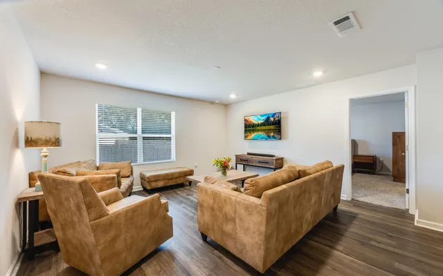 a living room with furniture and a flat screen tv