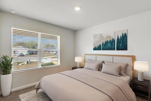 a bedroom with a balcony a bed and a potted plant