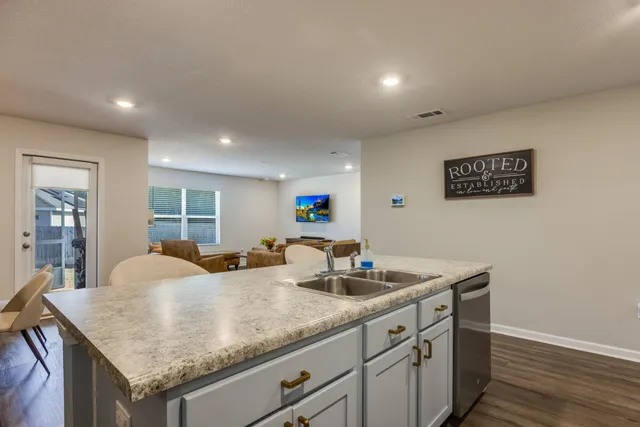 a kitchen with granite countertop a sink and cabinets