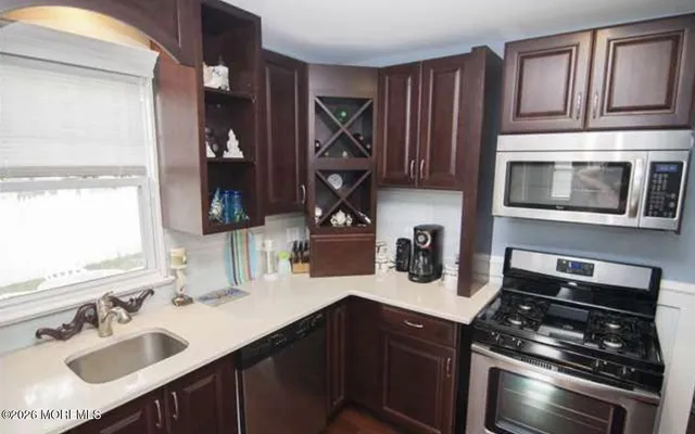 a kitchen with a sink stove and cabinets