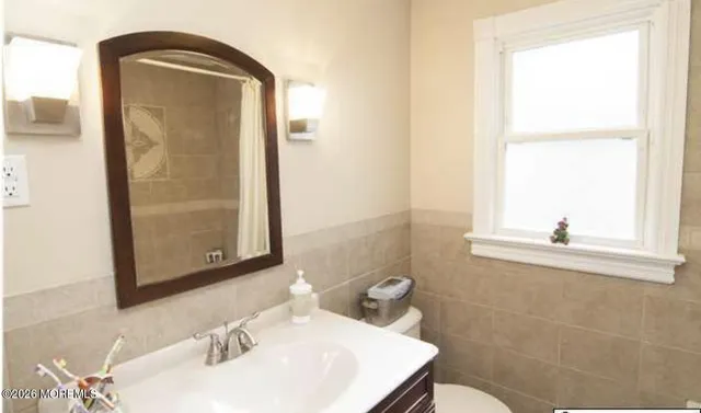 a bathroom with a sink a mirror and a window