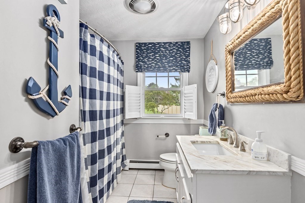 5 Atina Road Marshfield, MA 02050 - Photo 19 of 39 a bathroom with a sink a mirror a window and a shower