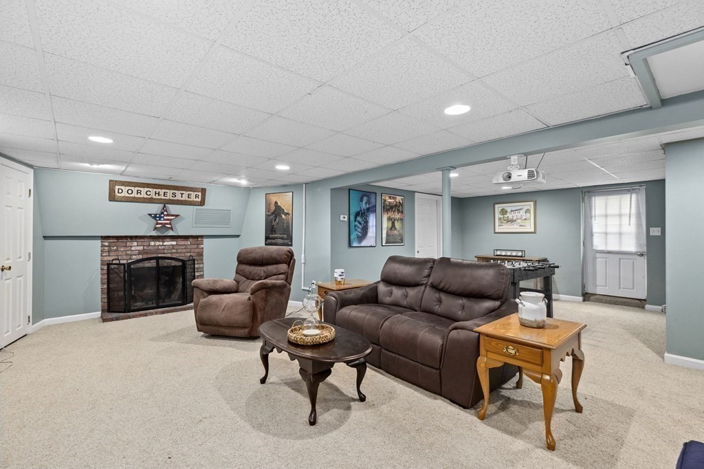 5 Atina Road Marshfield, MA 02050 - Photo 20 of 39 a living room with furniture and a fireplace