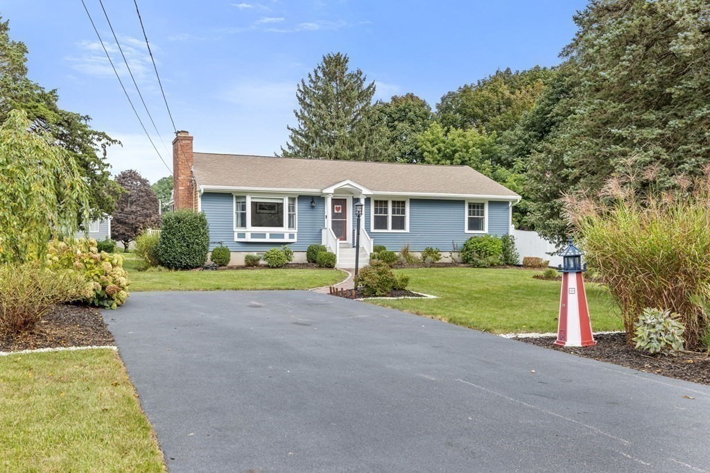 5 Atina Road Marshfield, MA 02050 - Photo 29 of 39 a front view of a house with a yard and garage