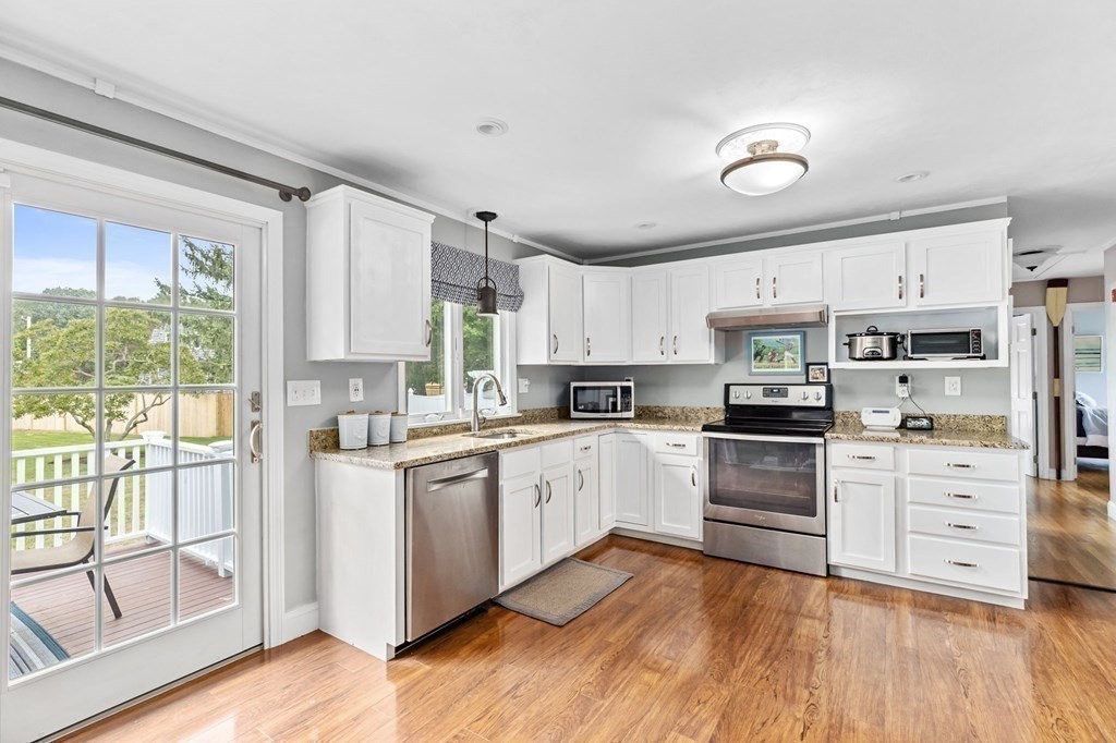 5 Atina Road Marshfield, MA 02050 - Photo 9 of 39 a kitchen with stainless steel appliances white cabinets and wooden floors