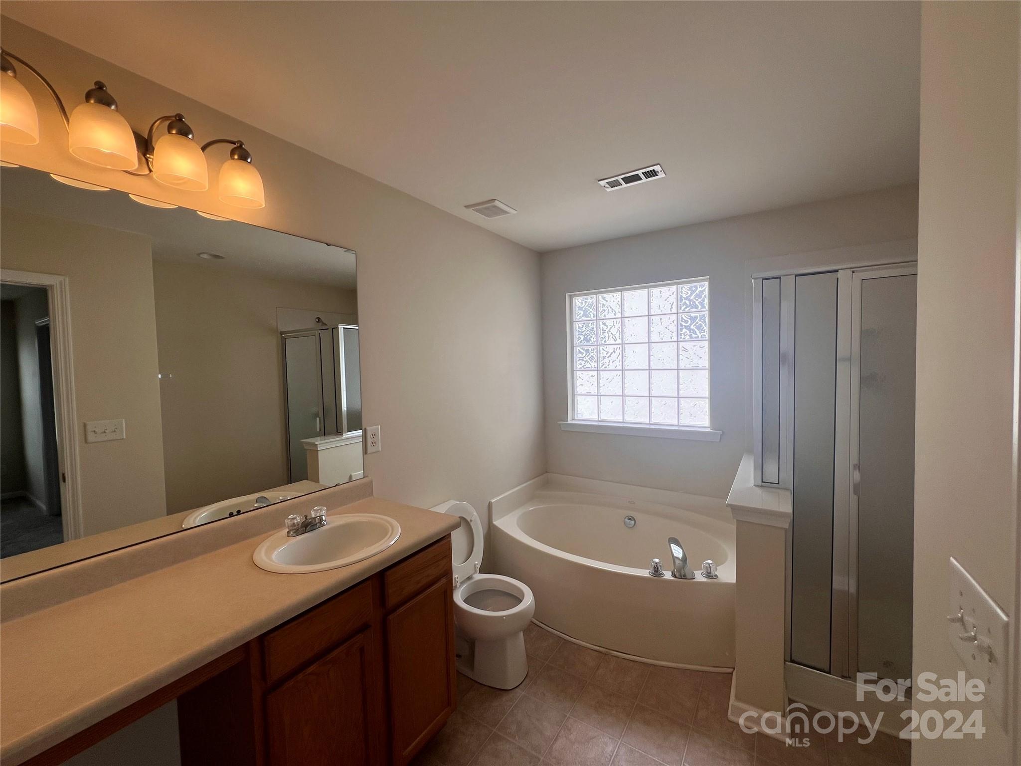6702 Ferrell Commons Road Charlotte, NC 28269 - Photo 17 of 20 a bathroom with a granite countertop tub sink and mirror
