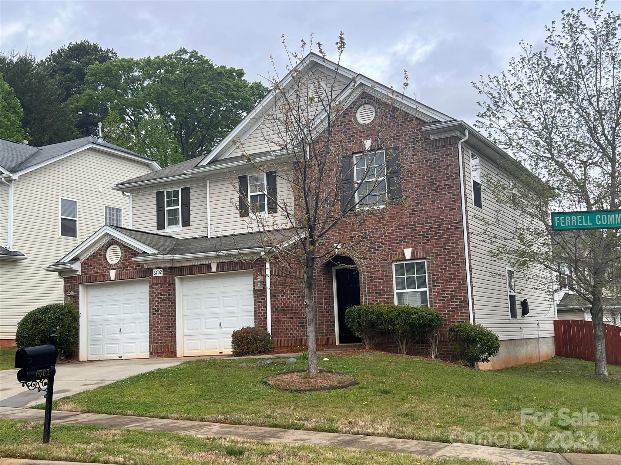 6702 Ferrell Commons Road Charlotte, NC 28269 - Photo 2 of 20 a front view of a house with a yard and garage