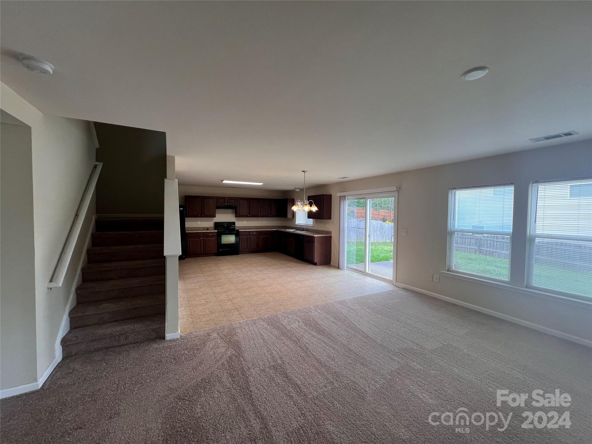 6702 Ferrell Commons Road Charlotte, NC 28269 - Photo 4 of 20 a view of empty room with fireplace and windows