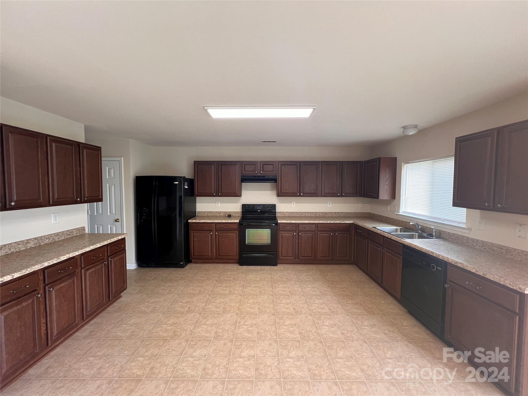 6702 Ferrell Commons Road Charlotte, NC 28269 - Photo 6 of 20 a large kitchen with a large counter top stainless steel appliances and cabinets