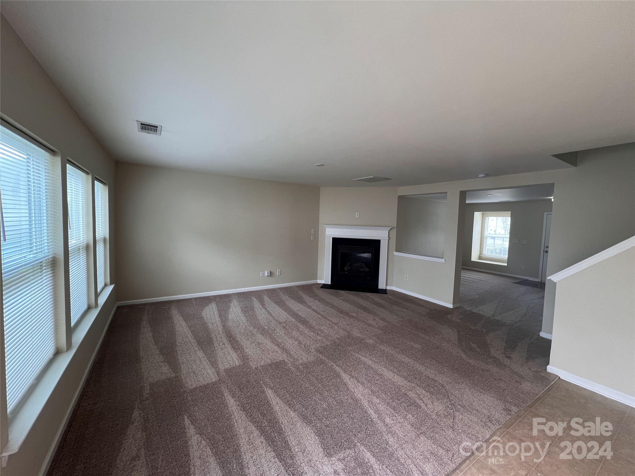 6702 Ferrell Commons Road Charlotte, NC 28269 - Photo 7 of 20 a view of empty room with window and fireplace