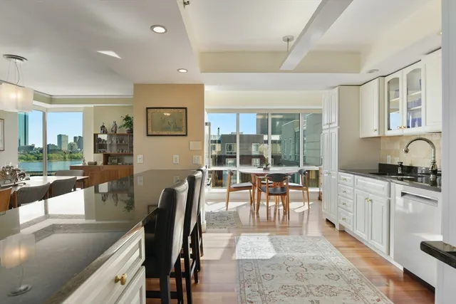 a large kitchen with lots of counter top space and dining table