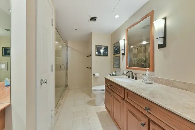 a spacious bathroom with a granite countertop sink mirror and double