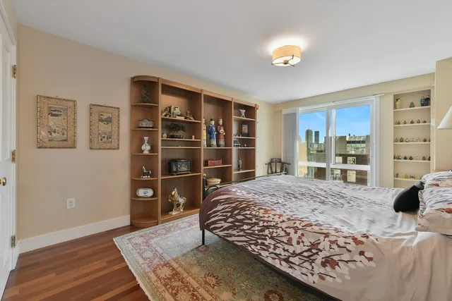 a bedroom with a bed and a window