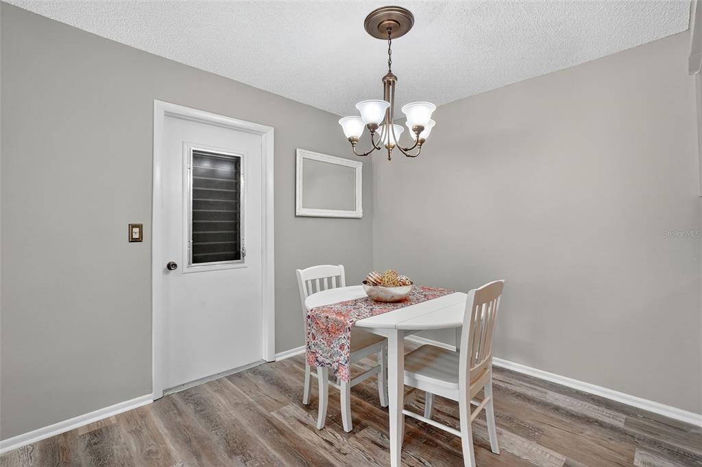 2320 Shelly Drive, Unit B Palm Harbor, FL 34684 - Photo 13 of 30 a view of a dining room with furniture and chandelier