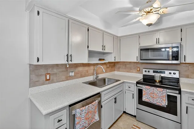 a kitchen with a sink stove and microwave
