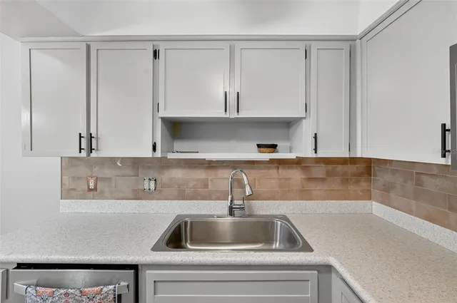 a kitchen with a sink and cabinets