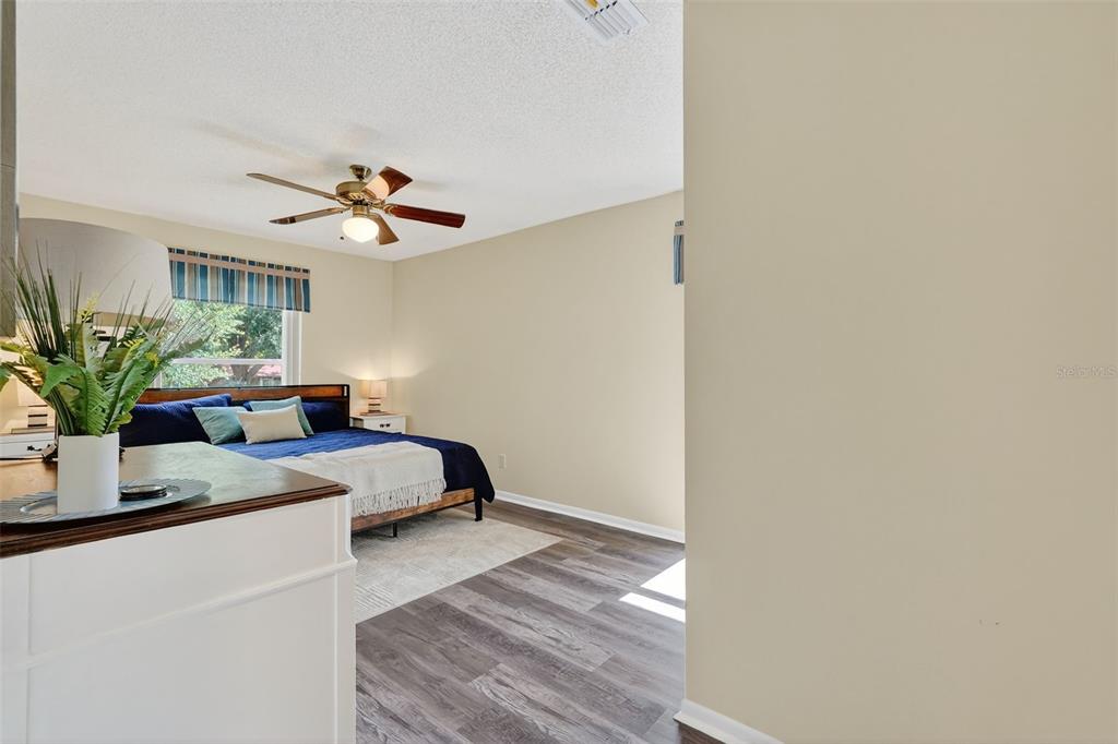 2320 Shelly Drive, Unit B Palm Harbor, FL 34684 - Photo 19 of 30 a bedroom with a bed and a potted plant