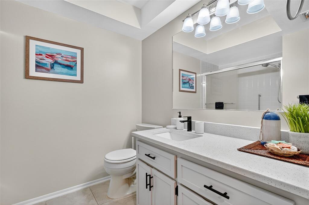 2320 Shelly Drive, Unit B Palm Harbor, FL 34684 - Photo 27 of 30 a bathroom with a toilet a sink and a mirror
