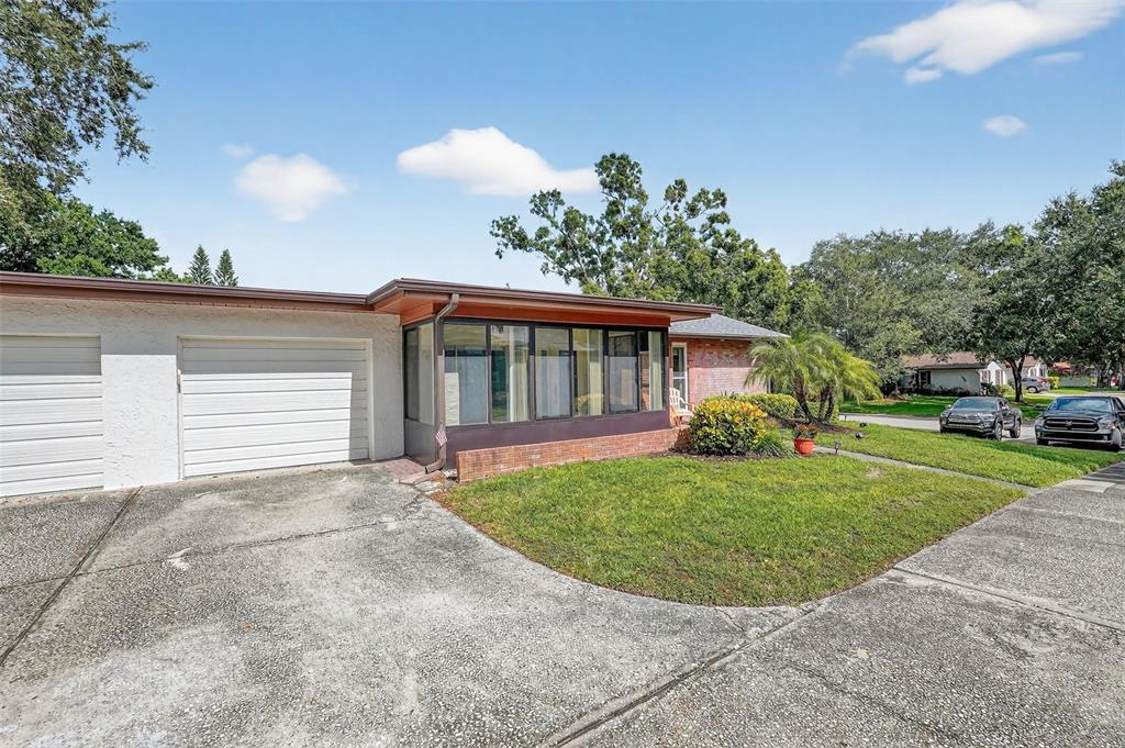 2320 Shelly Drive, Unit B Palm Harbor, FL 34684 - Photo 6 of 30 a view of a house with a yard and potted plants