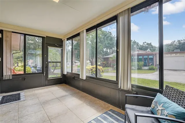 a living room with furniture and large windows
