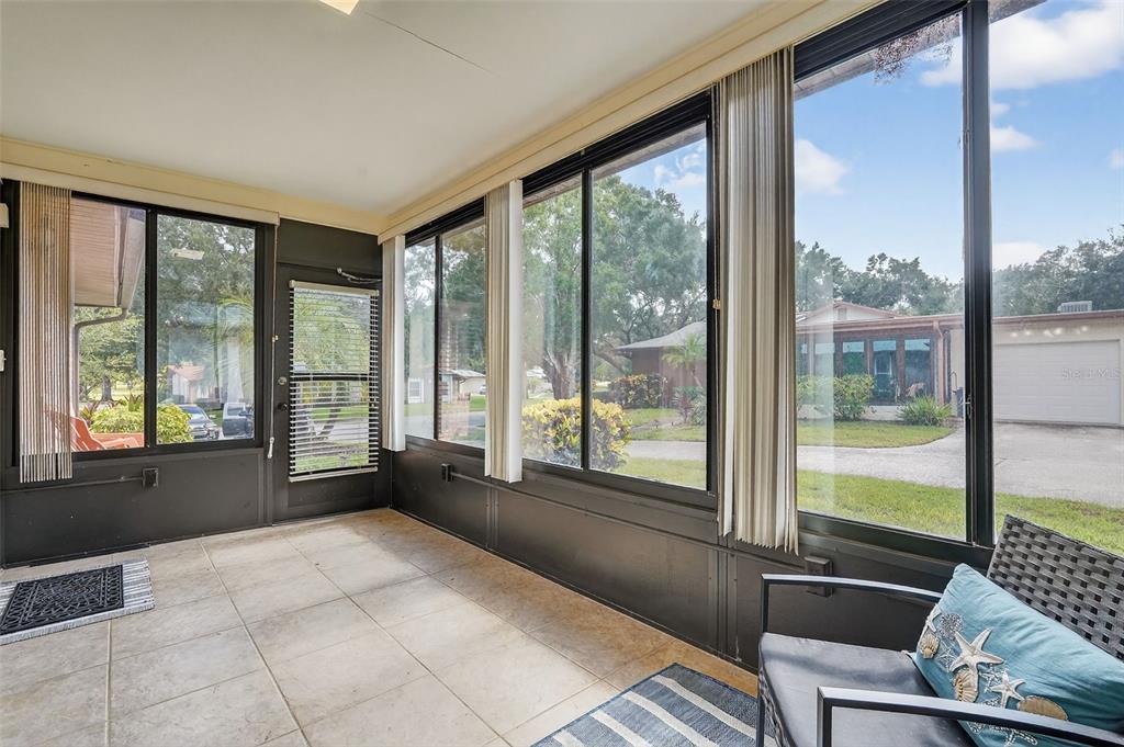 2320 Shelly Drive, Unit B Palm Harbor, FL 34684 - Photo 9 of 30 a living room with furniture and large windows