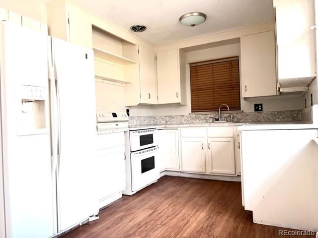 8640 Cherry Lane Westminster, CO 80031 - Photo 3 of 11 a kitchen with granite countertop a sink and cabinets with wooden floor
