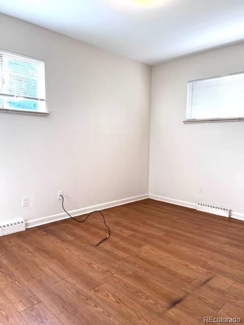 8640 Cherry Lane Westminster, CO 80031 - Photo 5 of 11 a view of an empty room with wooden floor and a window