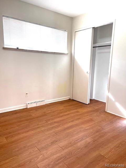 8640 Cherry Lane Westminster, CO 80031 - Photo 6 of 11 an empty room with wooden floor and a window