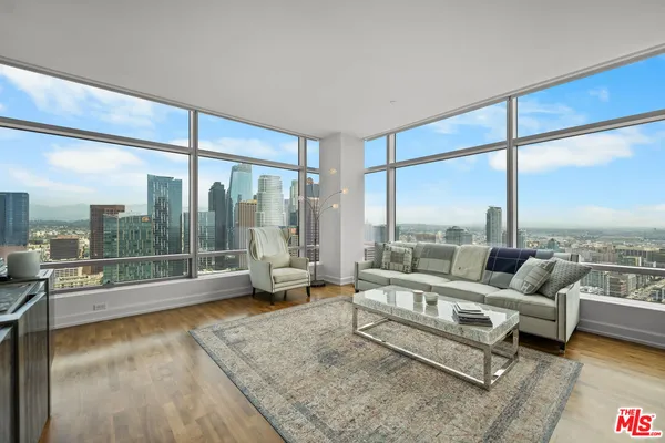 a living room with furniture and a floor to ceiling window