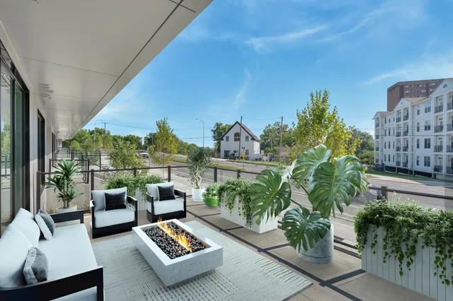 a balcony with furniture and a potted plant