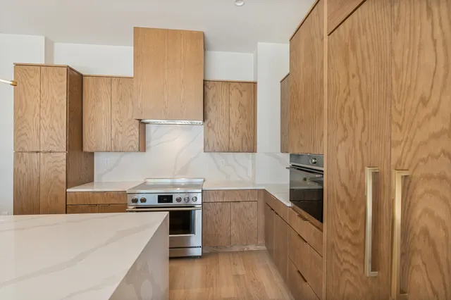 a kitchen with stainless steel appliances a refrigerator sink and stove